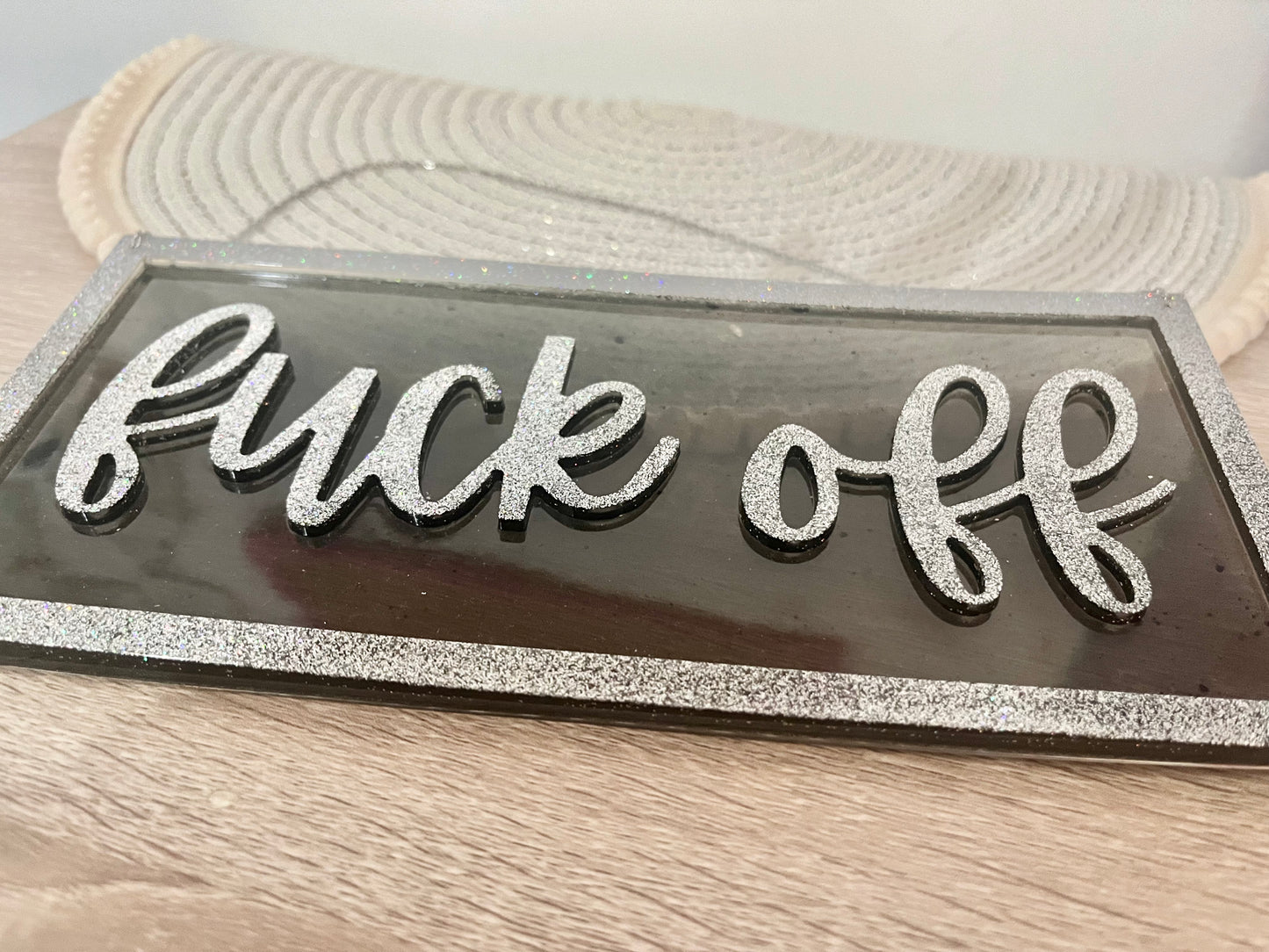 Sweary black and silver wall decor sign.